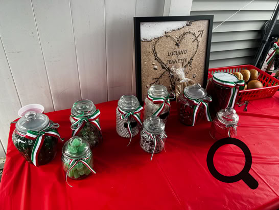 Charming dessert table setup featuring personalized cake pops and a tiered cake, perfect for celebrations.