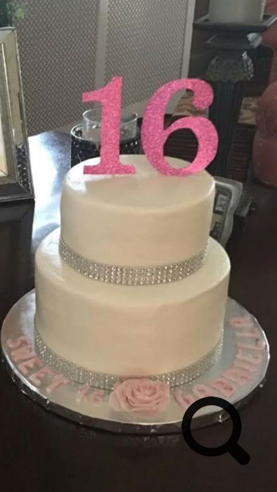 Charming dessert table setup featuring personalized cake pops and a tiered cake, perfect for celebrations.